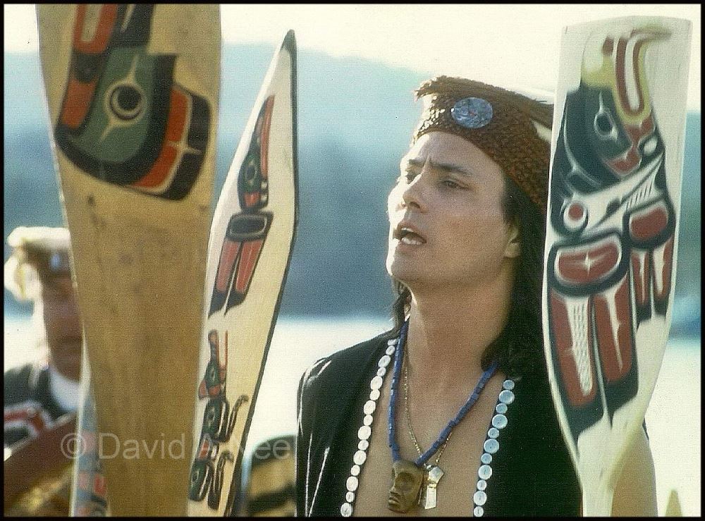 Wearing traditional Kwakiutl regalia, David speaking at a Northwest Native canoe gathering.